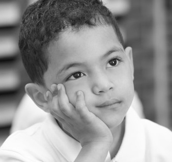 Young Boy leaning on his hand