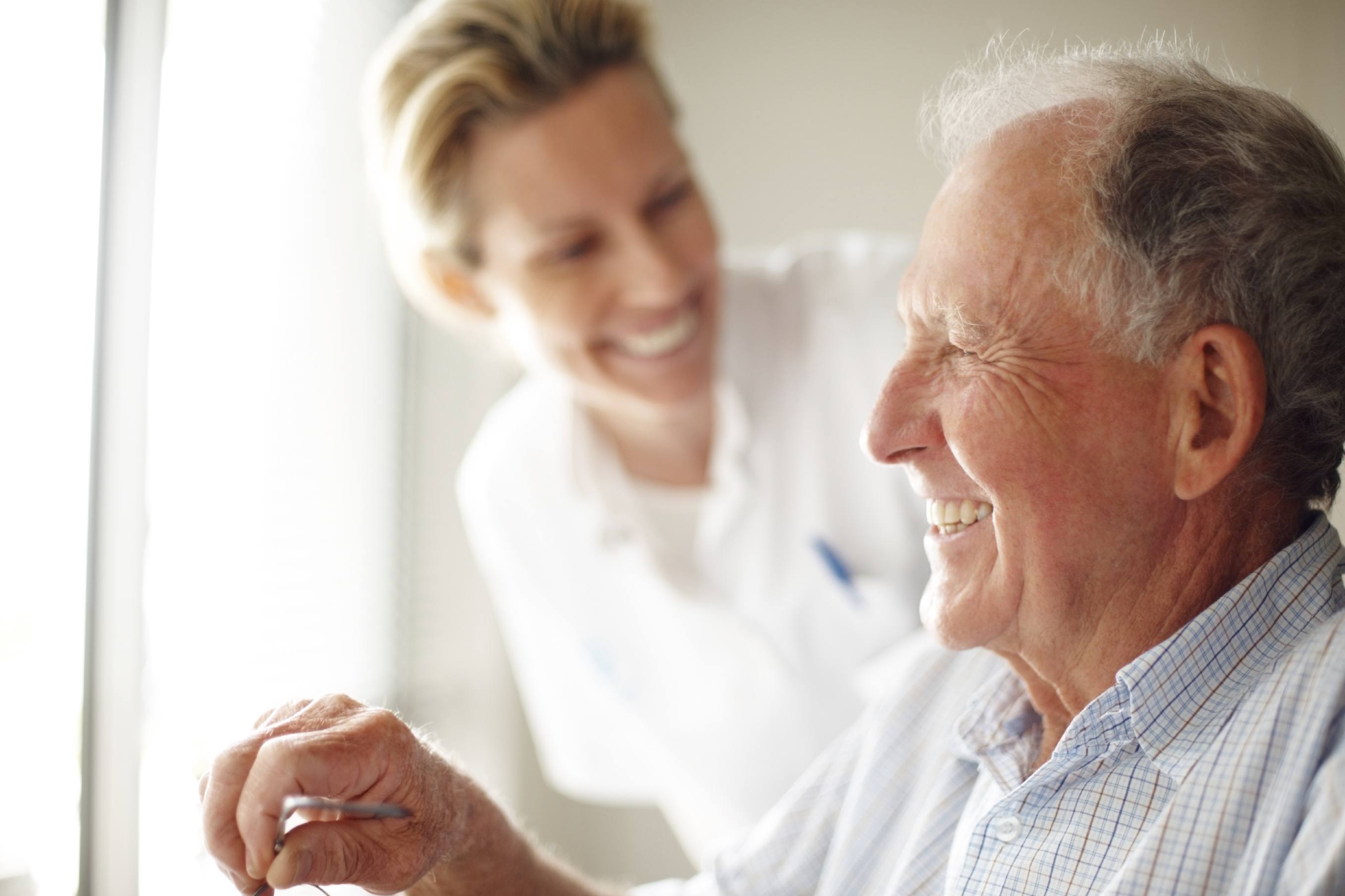 Nurse laughing with senior